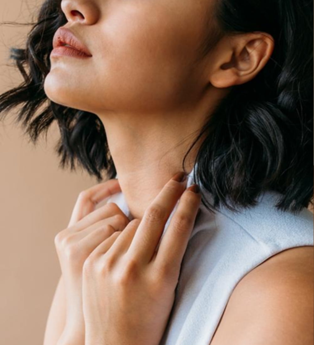 Portrait of a lady holding hands on neck | Teeth Clenching Reduction service in New York, NY | CONTŌR