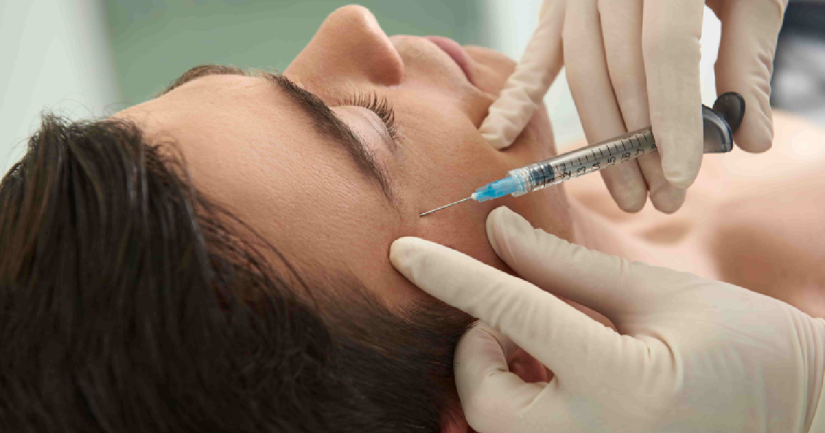 Person receiving a cosmetic injectable treatment for wrinkle prevention in New York, NY near the eye area, administered by a professional